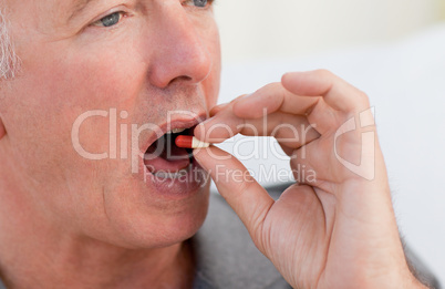 Retired man taking pills