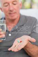 Retired man taking pills