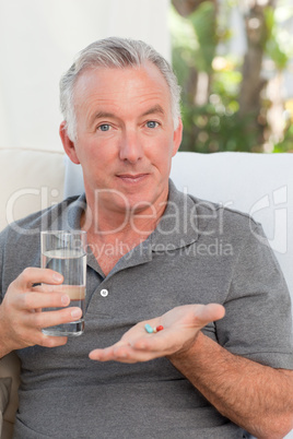 Retired man taking pills