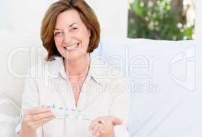 Cute mature woman with pills