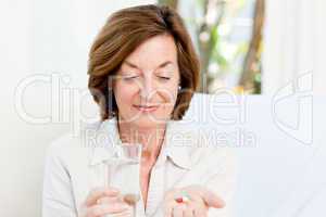 Cute mature woman with pills