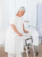 Senior woman looking at the camera with her zimmer frame