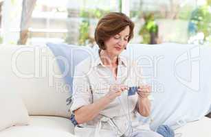 Woman knitting at home