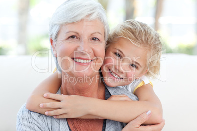 Lovely little girl with her grandmother looking at the camera