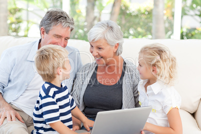 Adorable family looking at their laptop