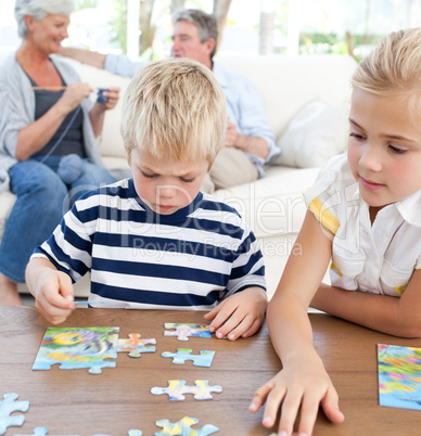 Children playing puzzle in the living room