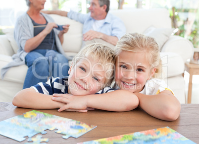 Children looking at the camera in the living room