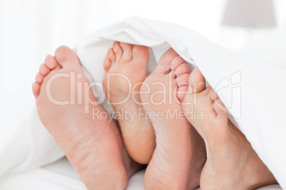 Family's feet in the bed