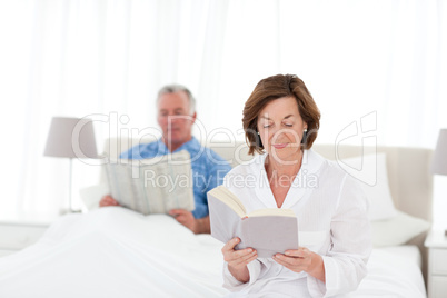 Couple reading together in the bed