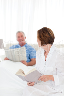 Couple reading together in the bed