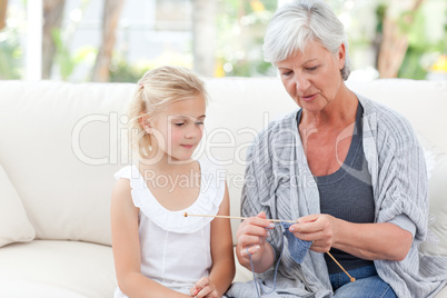 Senior knitting with her granddaughter