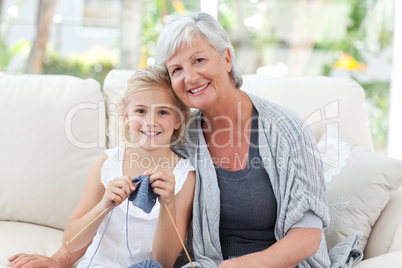 Senior with her granddaughter looking at the camera
