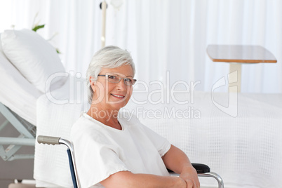 Senior woman in her wheelchair looking at the camera