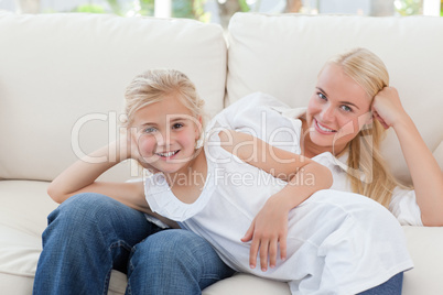 Beautiful woman lying down with her daughter