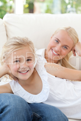 Beautiful woman lying down with her daughter