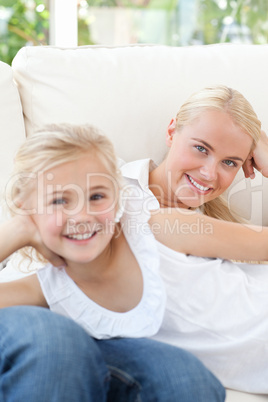 Beautiful woman lying down with her daughter