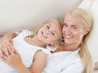 Beautiful woman lying down with her daughter