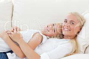 Beautiful woman lying down with her daughter