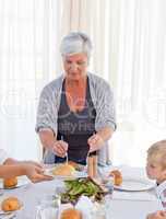 Grandmother serving her grandchildren