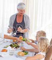 Grandmother serving her grandchildren