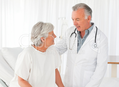 Doctor helping his patient to walk