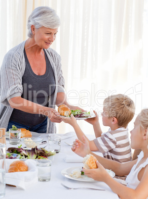 Grandmother serving her grandchildren Grandmother serving her grandchildren