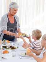 Grandmother serving her grandchildren