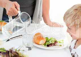 Grandmother serving her grandson at home