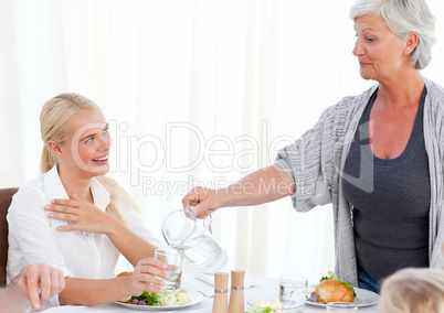 Aged woman serving her daughter