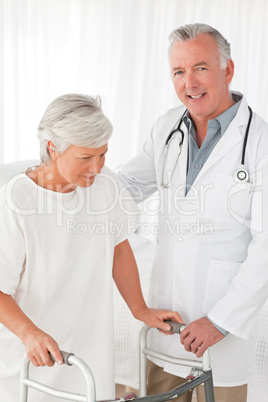 Doctor helping his patient to walk