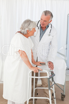 Doctor helping his patient to walk