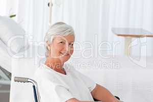 Senior woman in her wheelchair looking at the camera