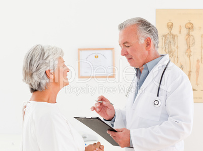 Senior doctor talking with his sick patient