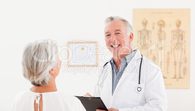 Senior doctor talking with his sick patient