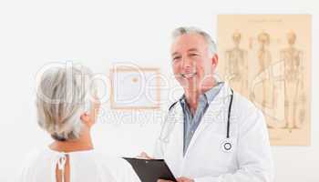 Senior doctor talking with his sick patient