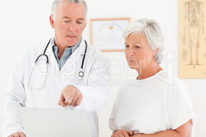 Doctor and his patient looking at the laptop