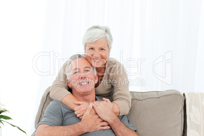 Lovers hugging while they are looking at the camera