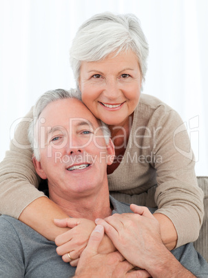 Lovers hugging while they are looking at the camera