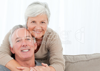 Lovers hugging while they are looking at the camera