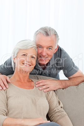 Lovers hugging while they are looking at the camera