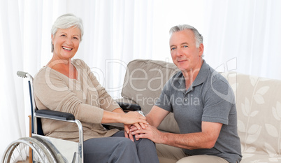 Man with his wife in a wheelchair