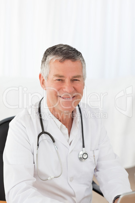 A senior doctor in his office