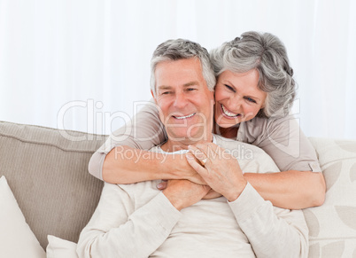 Mature woman hugging her husband