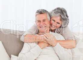 Mature woman hugging her husband