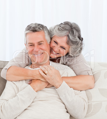 Mature woman hugging her husband