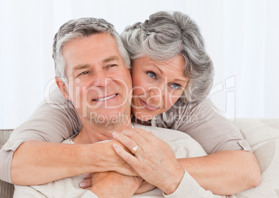 Mature woman hugging her husband