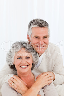 Mature couple looking at the camera at home