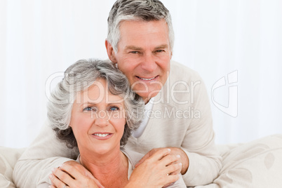 Mature woman hugging her husband