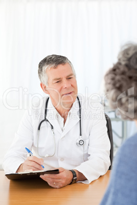 A senior doctor talking with his patient A senior doctor talking with his patient