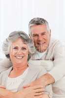 Mature couple looking at the camera at home